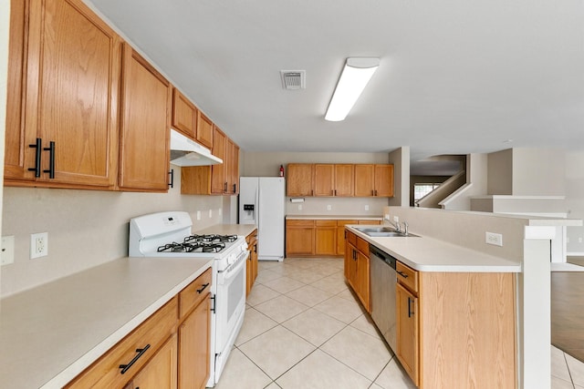 kitchen featuring sink, white appliances, an island with sink, and light tile patterned flooring