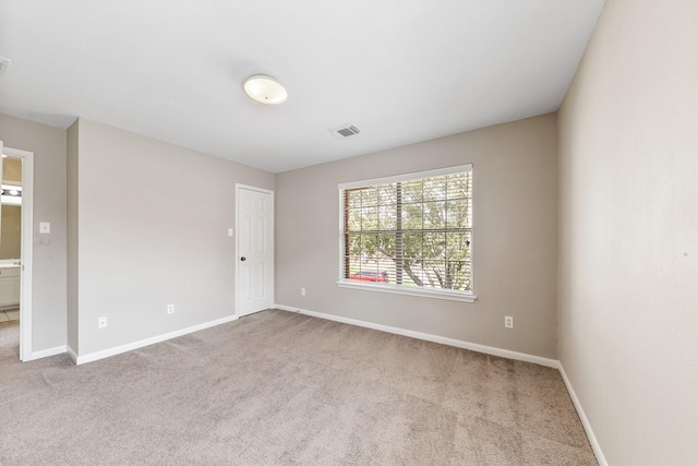 empty room featuring light carpet