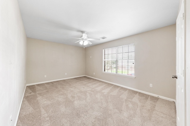 unfurnished room featuring ceiling fan and light carpet