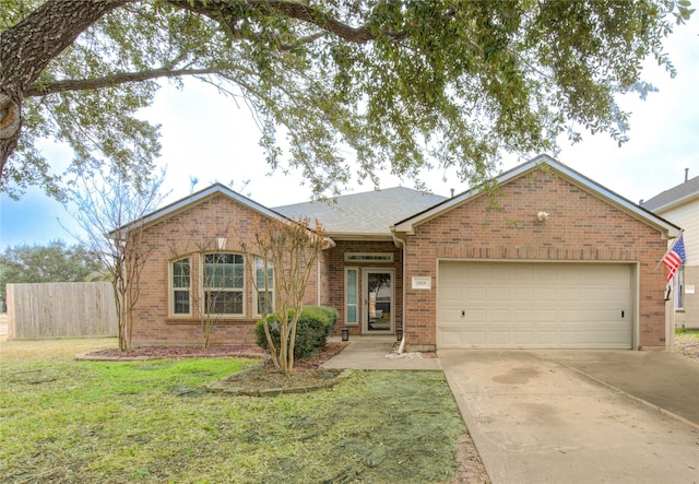 ranch-style home featuring an attached garage, brick siding, fence, driveway, and a front lawn