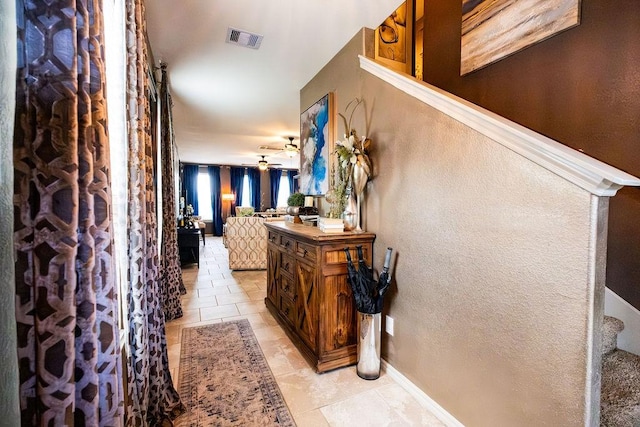 hall featuring light tile patterned floors