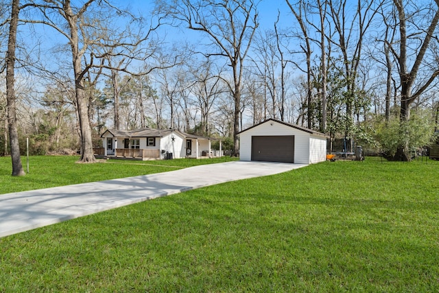 single story home with a garage, an outdoor structure, a front lawn, and covered porch