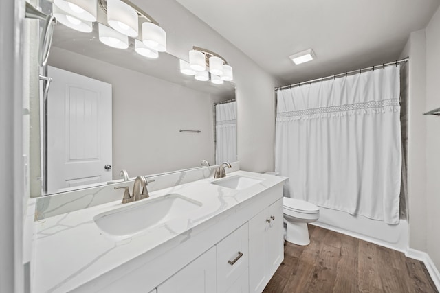 full bathroom featuring wood-type flooring, toilet, vanity, and shower / bath combo