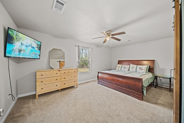 carpeted bedroom with a textured ceiling and ceiling fan