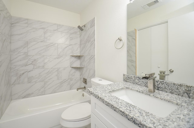 full bathroom featuring vanity, toilet, and tiled shower / bath