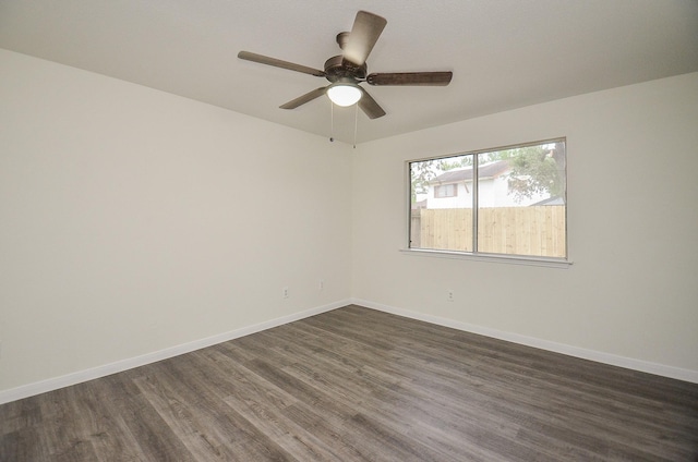 empty room featuring ceiling fan and dark hardwood / wood-style floors