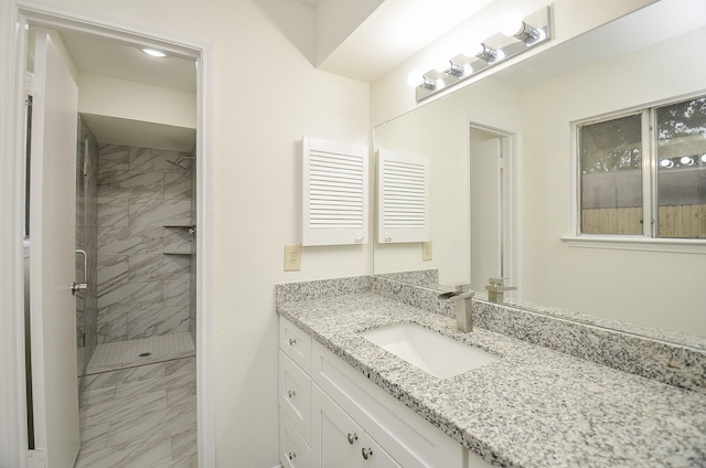 bathroom featuring vanity and a tile shower