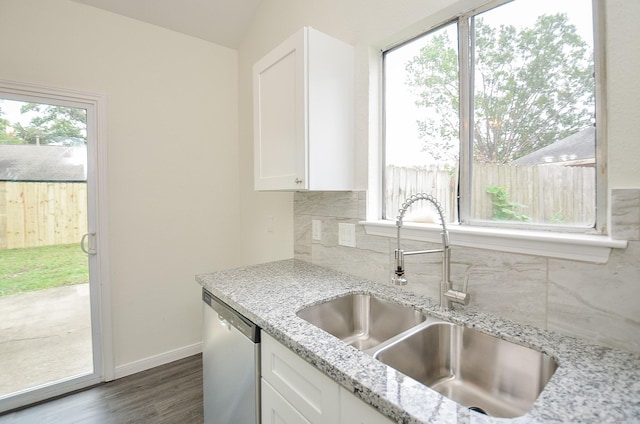 kitchen with white cabinetry, dishwasher, sink, and light stone counters