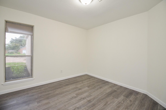 unfurnished room with dark hardwood / wood-style floors