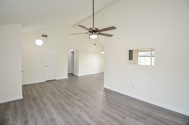 spare room featuring high vaulted ceiling, dark wood-type flooring, and ceiling fan