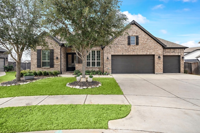 view of front of property featuring a garage and a front lawn