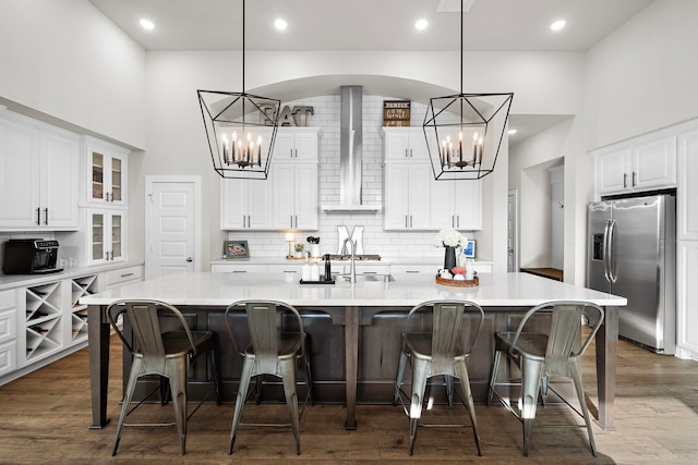 kitchen featuring a breakfast bar, stainless steel fridge, and a spacious island