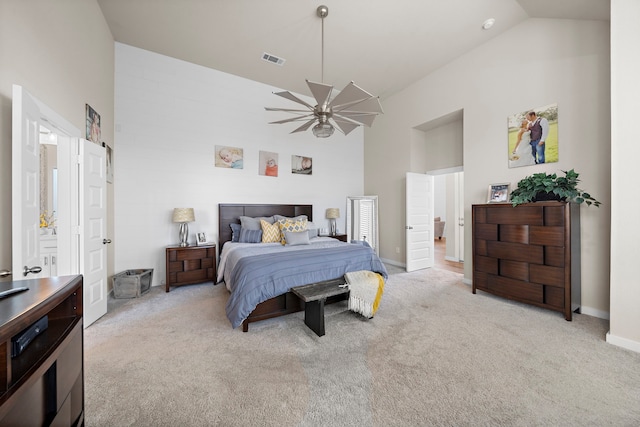 bedroom with high vaulted ceiling and light carpet