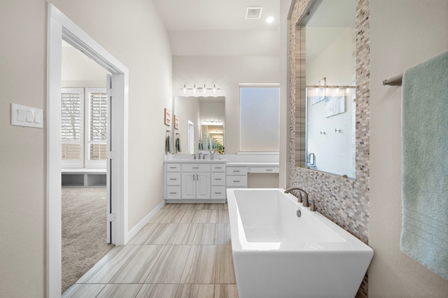 bathroom with vanity and a bath