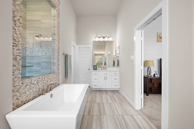 bathroom featuring vanity and independent shower and bath