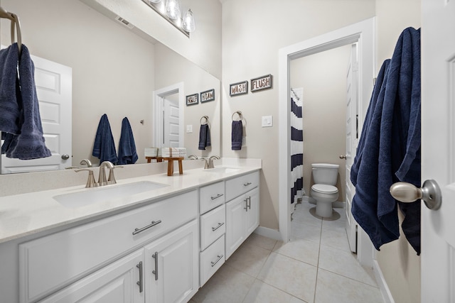 bathroom featuring a shower with shower curtain, vanity, toilet, and tile patterned flooring