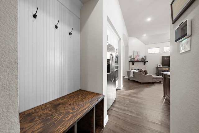 mudroom with dark hardwood / wood-style flooring and vaulted ceiling