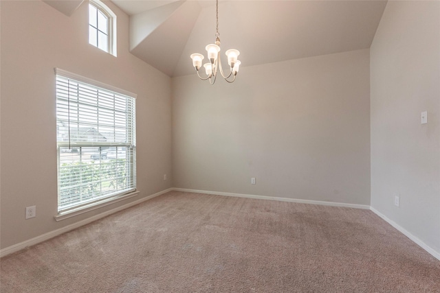 carpeted empty room featuring high vaulted ceiling and an inviting chandelier