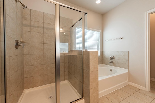 bathroom featuring independent shower and bath and tile patterned flooring