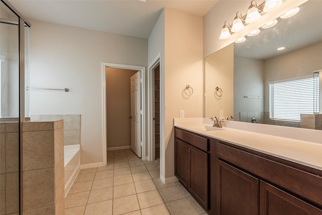 bathroom featuring vanity, a bath, and tile patterned floors