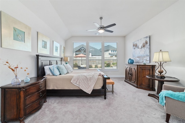 bedroom featuring light carpet, lofted ceiling, and ceiling fan