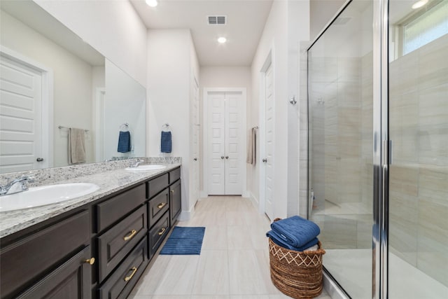 bathroom with vanity, tile patterned flooring, and a shower with shower door