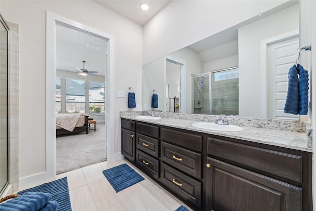 bathroom featuring vanity, tile patterned floors, a shower with shower door, and a healthy amount of sunlight