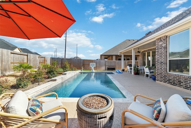 view of swimming pool with ceiling fan and a patio