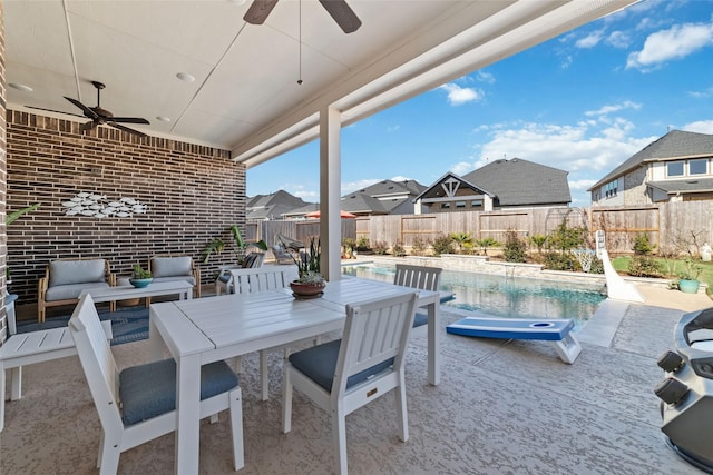 view of patio / terrace with ceiling fan and a fenced in pool