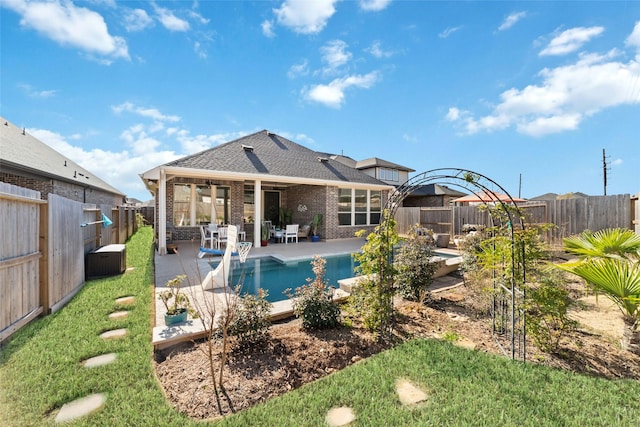 view of swimming pool with a yard and a patio area