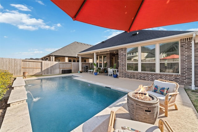 view of pool featuring a fenced in pool, a fire pit, a fenced backyard, and a patio area