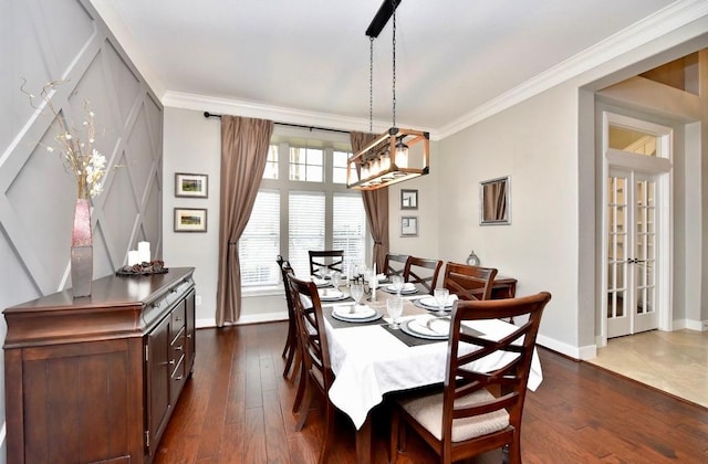 dining room featuring dark wood-style floors, crown molding, and baseboards