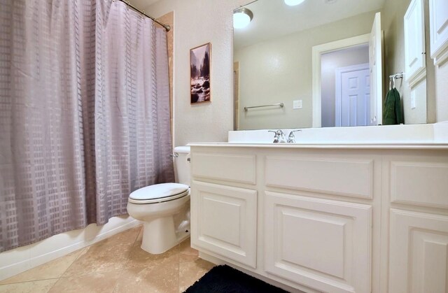 bathroom featuring shower / bath combo with shower curtain, tile patterned flooring, vanity, and toilet