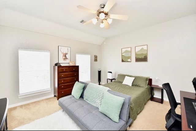 bedroom featuring light carpet, baseboards, visible vents, and lofted ceiling