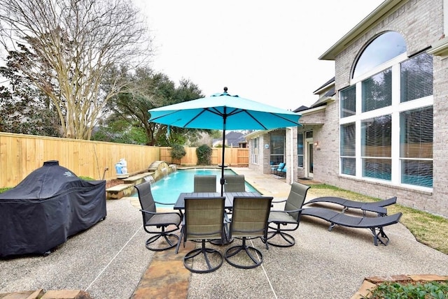 view of patio featuring a fenced in pool, outdoor dining area, and a fenced backyard