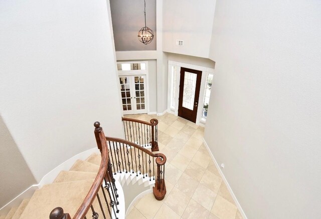 entryway featuring visible vents, baseboards, a notable chandelier, and french doors