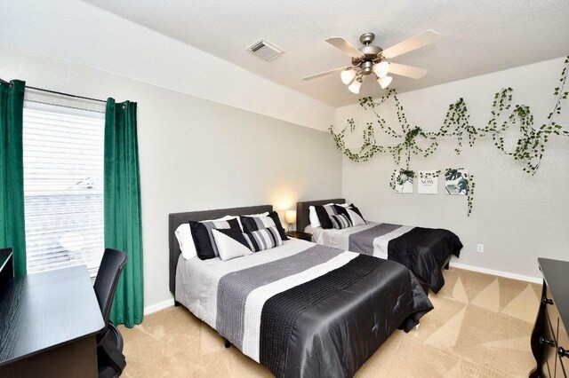 bedroom featuring baseboards, visible vents, and light colored carpet