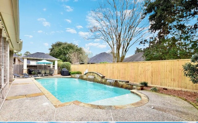 view of swimming pool with a patio area, a fenced backyard, and a fenced in pool