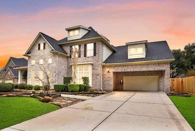 view of front of house featuring a yard and a garage