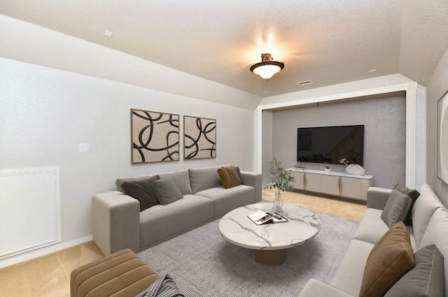 carpeted living room featuring vaulted ceiling, a textured ceiling, visible vents, and baseboards