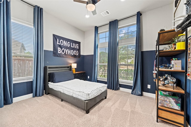 bedroom featuring visible vents, carpet floors, baseboards, and ceiling fan