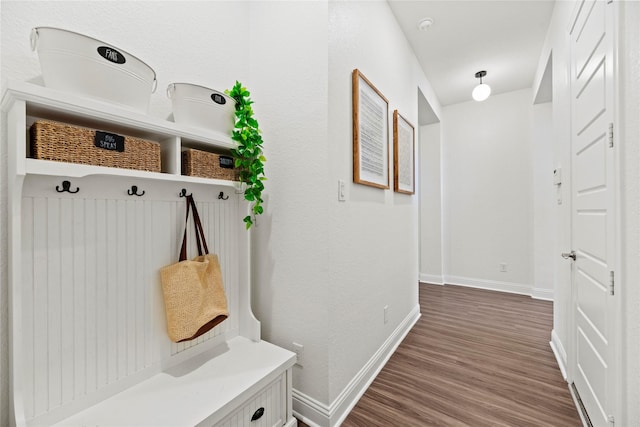 mudroom featuring dark wood-style floors and baseboards