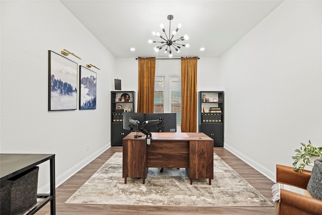 office space featuring recessed lighting, baseboards, an inviting chandelier, and wood finished floors