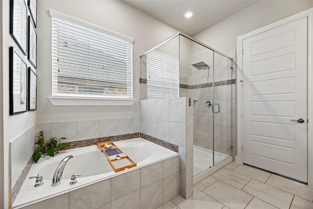 bathroom with a garden tub, a shower stall, and tile patterned flooring