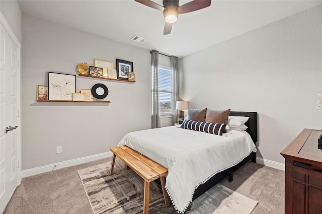 bedroom with ceiling fan, light colored carpet, visible vents, and baseboards