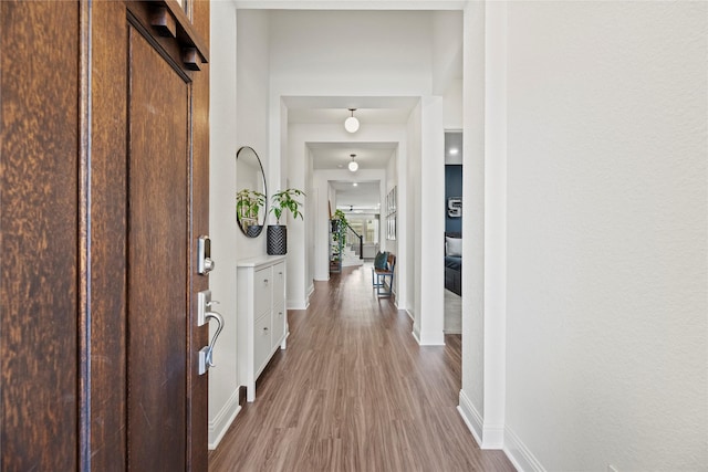 interior space featuring baseboards and wood finished floors