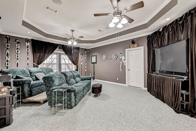 living room with crown molding, a raised ceiling, ceiling fan, and carpet flooring