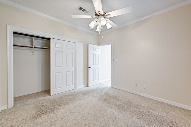 unfurnished bedroom featuring ceiling fan, light colored carpet, ornamental molding, and a closet