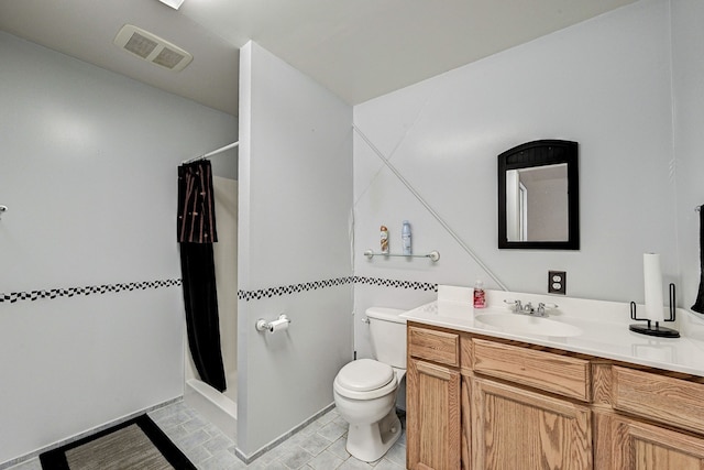 bathroom featuring walk in shower, tile patterned floors, vanity, and toilet