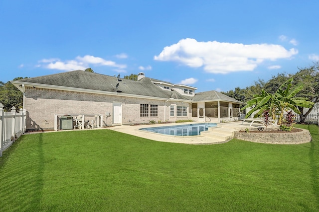 rear view of property with a yard and a patio area